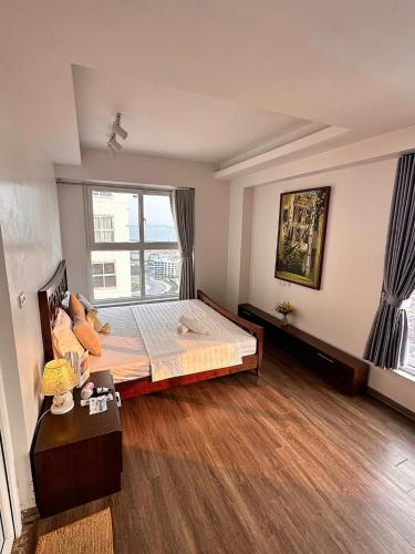 a bedroom with a bed and a large window at Chuỗi Homestay Bãi Cháy Hạ Long in Ha Long