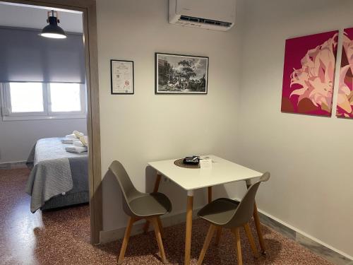 a room with a table and two chairs and a bed at TERRA HOMERICA in Chios