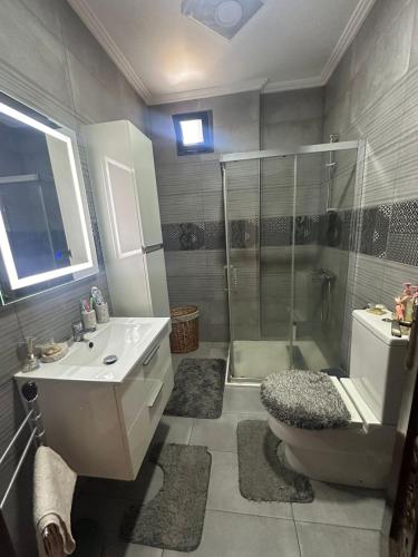 a bathroom with a shower and a toilet and a sink at Location villa vacances sur tanger in Tangier
