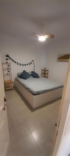 a bedroom with a bed with blue pillows on it at Mediterranien Terrace in Calella