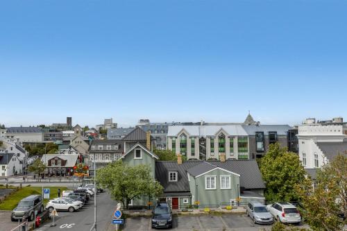 a city with cars parked in a parking lot at Berg Apartments in Reykjavík