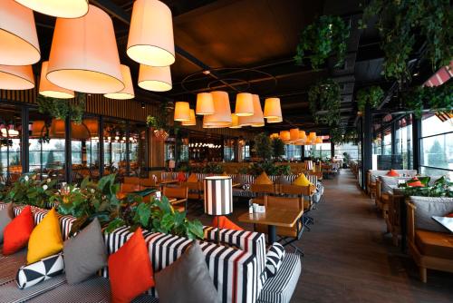 a restaurant with tables and chairs and potted plants at Fier Life Center in Kayseri