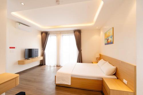 a bedroom with a bed and a television in it at Chuỗi Homestay Bãi Cháy Hạ Long in Ha Long