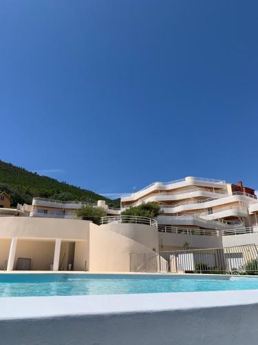 a view of a building with a swimming pool at Cap Neree Petit coin de paradis pieds dans l eau in Saint-Raphaël