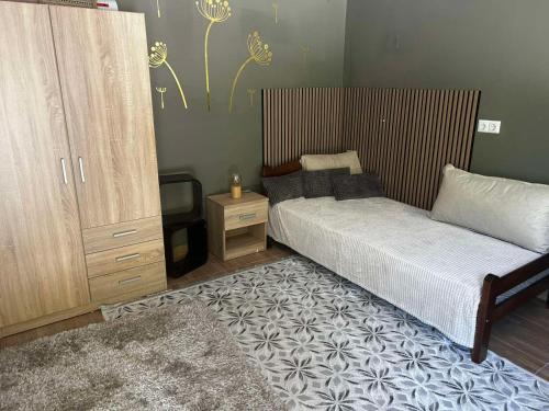 a bedroom with a bed and a cabinet and a television at Vila Lush in Sarajevo
