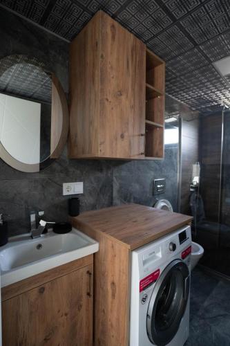 a kitchen with a washing machine and a sink at MSD Konakları in Koycegiz
