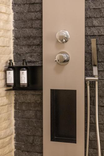 a door with two candles on a brick wall at Noto Boutique Hotel in Noto
