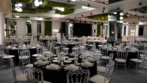 a room full of tables and chairs with whiteitures at Fier Life Center in Kayseri