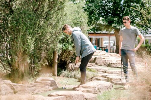 two men are playing a game on some rocks at Romantic Wine Estate Stay in The Midlands in Howick