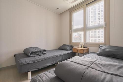 une chambre avec deux lits et une fenêtre dans l'établissement Glan House & Glan Store, à Séoul