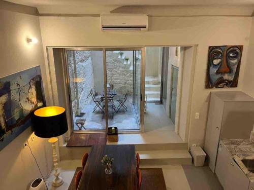 a living room with a table and a large window at Oporto Downtown Almada Garden Apartments by LuxiStay in Porto