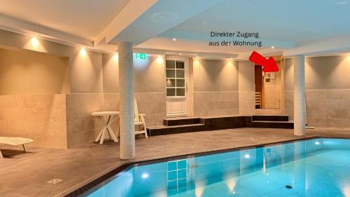 a pool in a hotel room with a hotel sign at Syltrose Whg 1a in Westerland (Sylt)