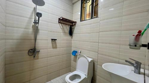 a bathroom with a toilet and a sink at Skill forest lodge in Arusha