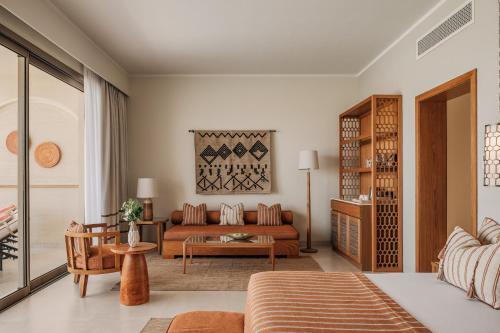 a living room with a couch and a table at Sakhra Hotel & Spa, Almaza Bay in Marsa Matruh
