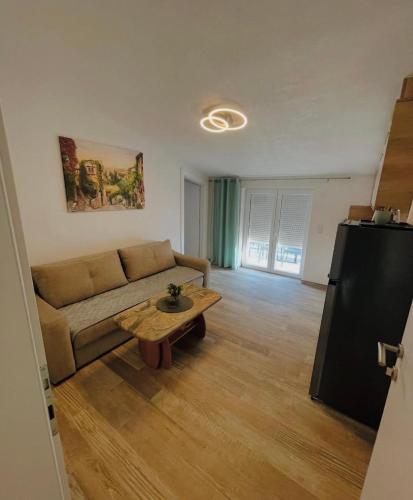 a living room with a couch and a coffee table at Apartments Ravlic in Neum