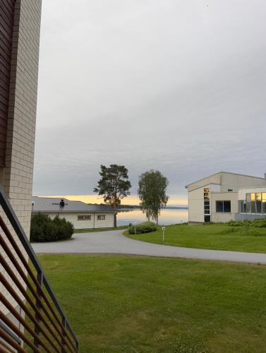 a view of a house and the ocean in the distance at Kraatterin Helmi Suite in Lappajärvi