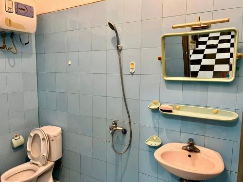 a bathroom with a sink and a toilet and a mirror at Hnhome28 in Hanoi