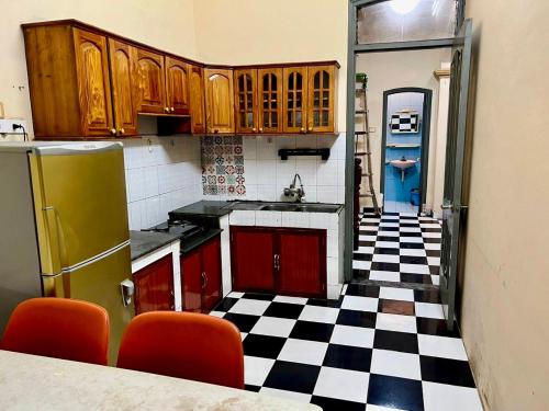 a kitchen with a black and white checkered floor at Hnhome28 in Hanoi