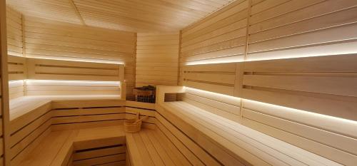 a wooden sauna with wooden floors and wooden walls at Montenegrina Hotel & SPA All-Inclusive in Becici