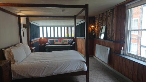 a bedroom with a bed and a couch in it at Alma Inn & Dining Rooms in Harwich