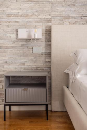 a bedroom with a bed and a bedside table at Noto Boutique Hotel in Noto