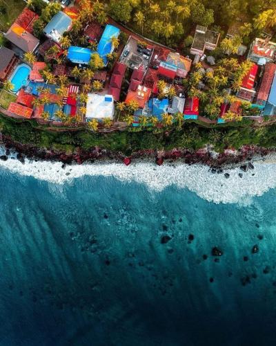 an aerial view of a resort next to the ocean at ARONIC beach hotel in Varkala