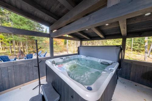 a jacuzzi tub on the back of a house at Spa and Nature - Chalet des Pins Rouge in Saint-Paul-de-Montminy