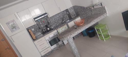 an overhead view of a kitchen with a granite counter top at Ola Blanca in Dar Hamida