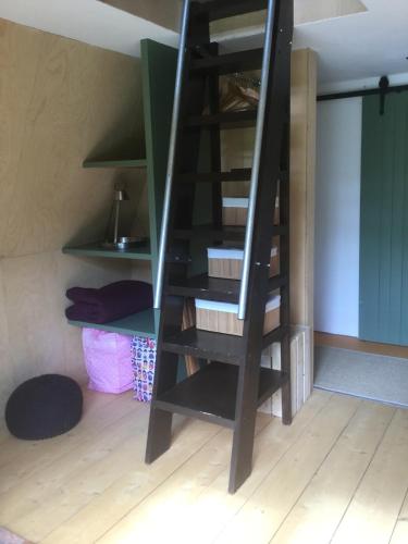 a wooden staircase in a room with a room at Aframe Tiny Home SILVA with private hot tub in Cowes