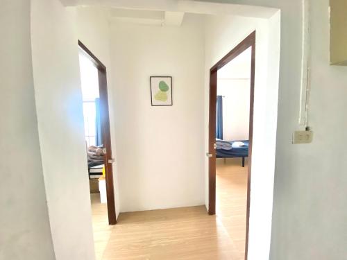 an open hallway with two doors to a room at Cozy Room Near Mahidol University For International Students in Sathani Sala Ya