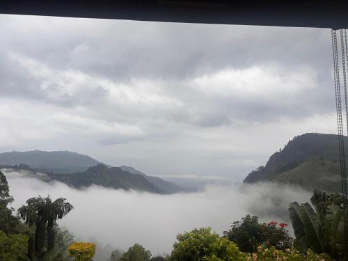 a view of a foggy valley with mountains in the background at Ambiente Guest House in Ella