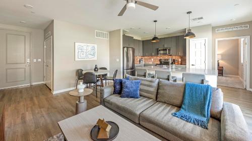 a living room with a couch and a kitchen at Landing Amazing 1BD Gym Clubhouse in Phoenix