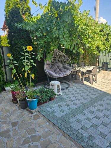 a patio with a bench and some plants and a table at Villa Kasinda in Sarajevo