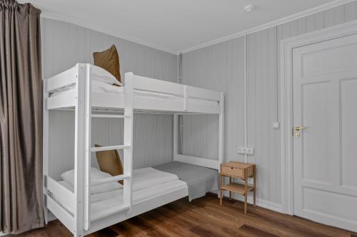 a white bunk bed in a room with a door at Berg Apartments in Reykjavík