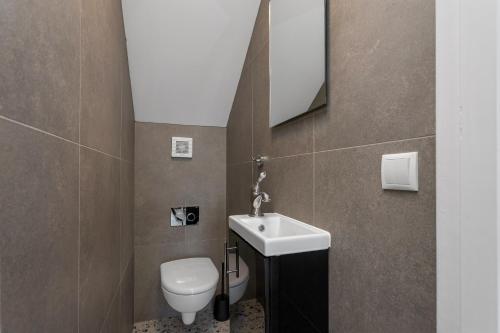 a bathroom with a sink and a toilet at Berg Apartments in Reykjavík