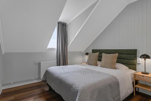 a bedroom with a large bed and a window at Berg Apartments in Reykjavík