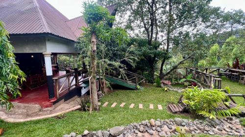 a house with a garden in front of it at Skill forest lodge in Arusha
