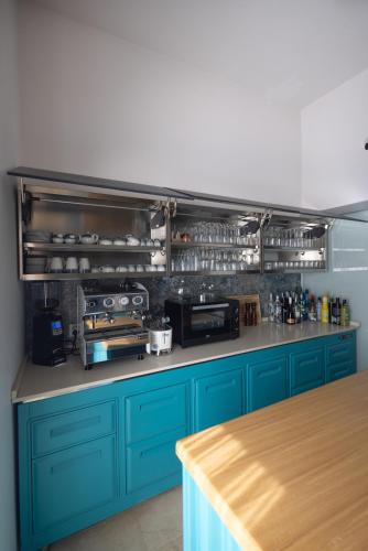 a kitchen with blue cabinets and a counter top at Noto Boutique Hotel in Noto