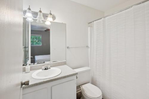 a white bathroom with a sink and a toilet at Kenridge Apartments 1635 I Comfy 2 Bed 2 Bath in Decatur