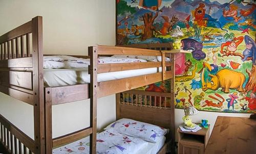 a bedroom with two bunk beds and a mural at Casa Mariarosa in Maccagno Inferiore