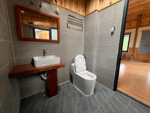 a bathroom with a toilet and a sink at Sapa Hmong Bungalow Homestay in Sa Pa