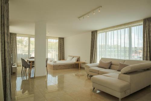a living room with two couches and a table at апартаменти Пасажио in Sandanski