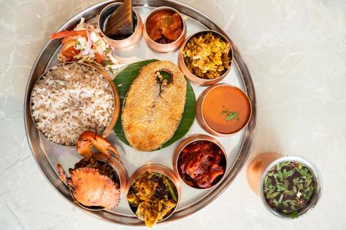 a plate filled with different types of food on a table at Fairfield by Marriott Goa Benaulim in Benaulim