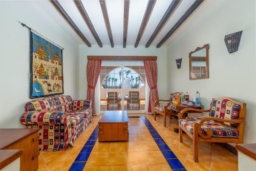 a living room with two couches and a table at Grand Makadi - Couples and Families Only in Hurghada