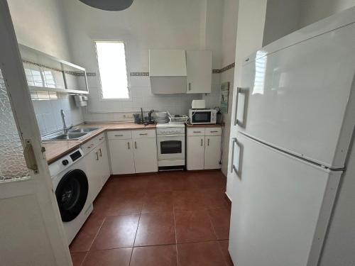 a kitchen with white appliances and a white refrigerator at AmazINN Places Casa Calabuig Ático Marina Real - No Ascensor- in Valencia