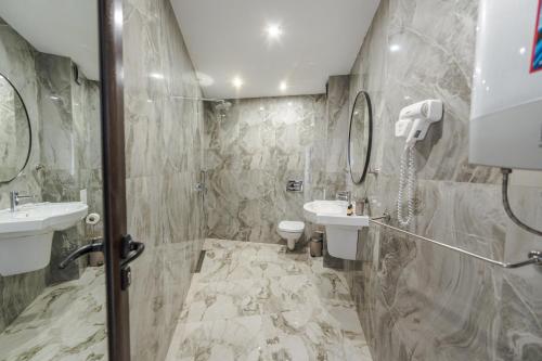a bathroom with a sink and a toilet at апартаменти Пасажио in Sandanski