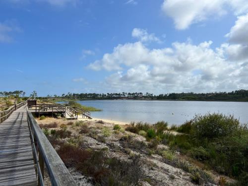 a wooden bridge over a body of water at Chale dos Sobreiros in Bicas