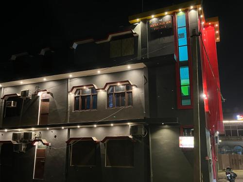 a building with windows and lights on it at night at The Aryakulam Heaven Near Ayodhya Dham in Ayodhya