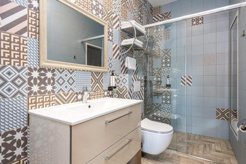 a bathroom with a sink and a toilet and a mirror at Radailiu Dvaras - Dinosaur Park in Radailiai