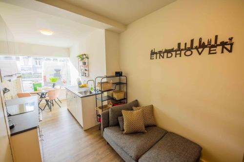 a living room with a couch and a kitchen at Stylish 50m2 Two-Bedroom Apartment - SD23K in Eindhoven